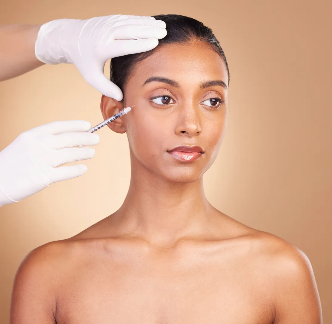 A doctor placing dermal filler with precision at Wellface Cobham
